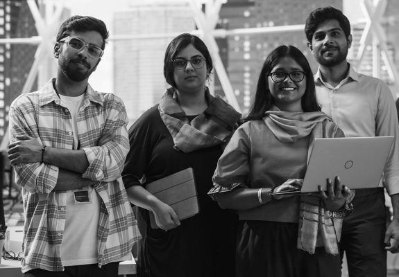 Group of Happy Multiethnic Indian Team of Female and Male Managers, Specialists and Business Professionals Posing for Camera and Smiling. Portrait of a Confident South Asian Team Leader Standing First