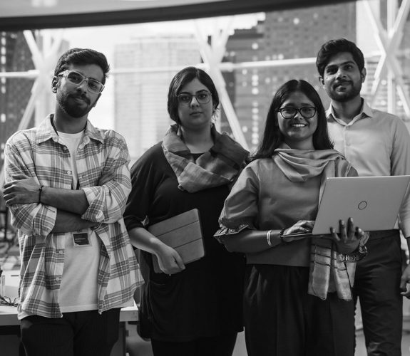 Group of Happy Multiethnic Indian Team of Female and Male Managers, Specialists and Business Professionals Posing for Camera and Smiling. Portrait of a Confident South Asian Team Leader Standing First